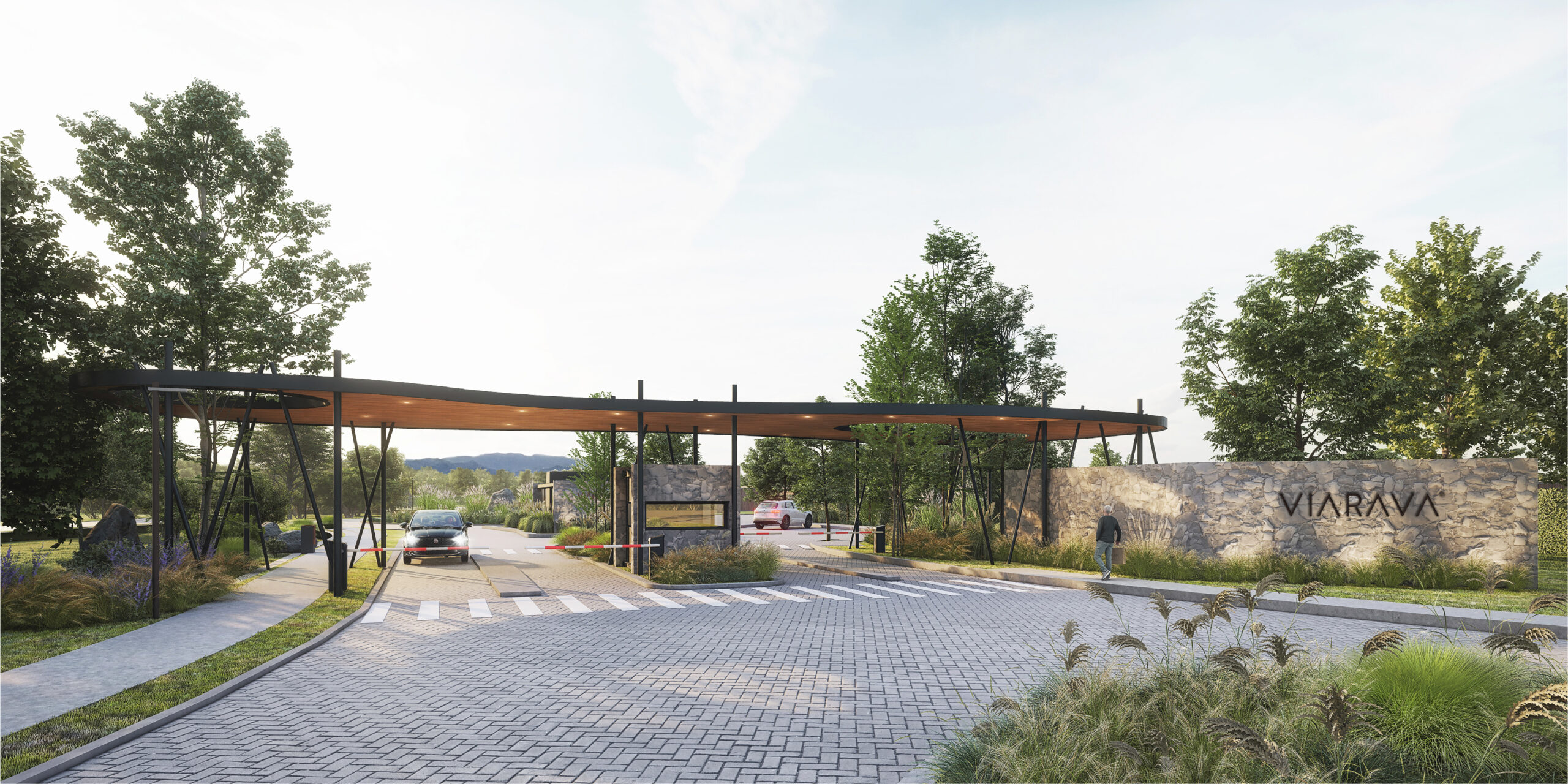 Ingreso a Viarava, barrio privado en Sierras Chicas, con portal moderno, caseta de seguridad, barreras vehiculares y entorno natural con vegetación y piedra.